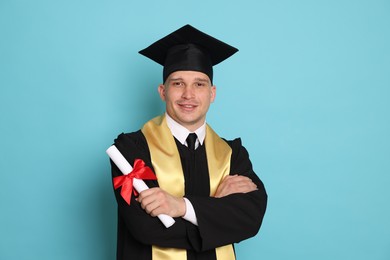 Photo of Happy student with diploma after graduation on light blue background