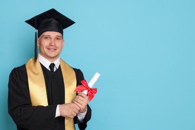 Photo of Happy student with diploma after graduation on light blue background. Space for text