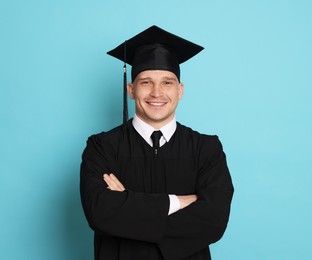 Photo of Happy student after graduation on light blue background