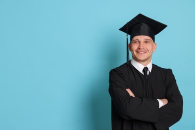 Photo of Happy student after graduation on light blue background. Space for text