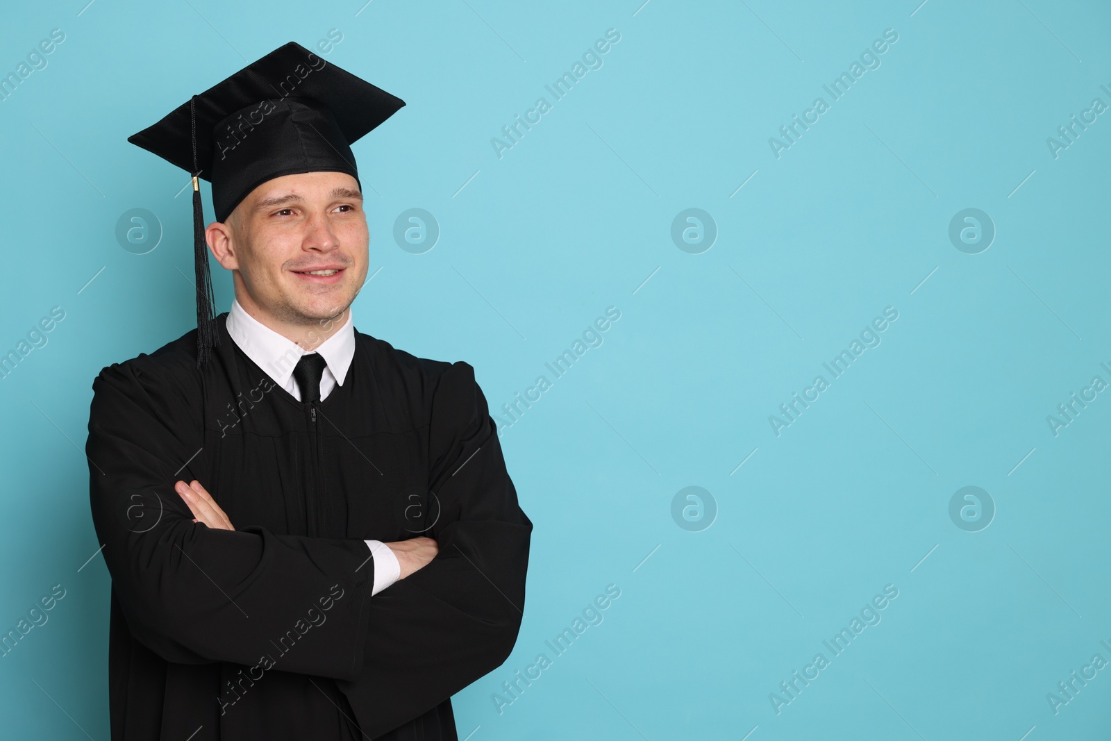Happy student after graduation on light blue background. Space for text Photo of Happy student after graduation on light blue background. Space for text