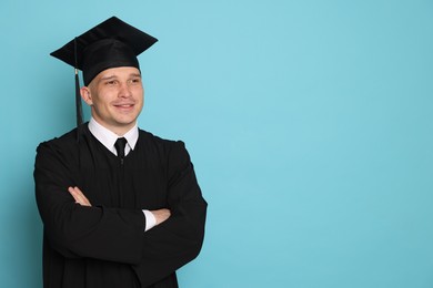 Photo of Happy student after graduation on light blue background. Space for text