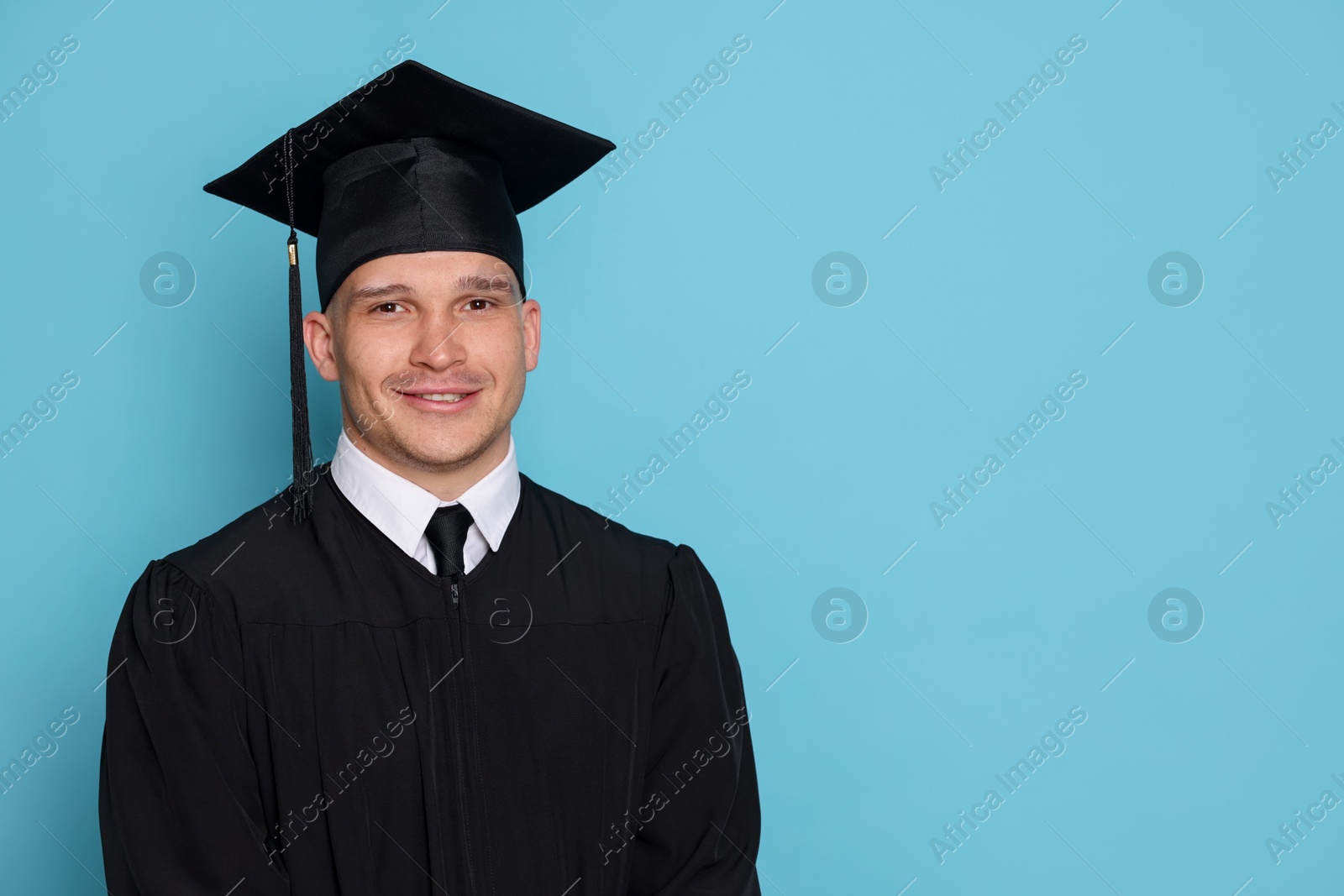 Happy student after graduation on light blue background. Space for text Photo of Happy student after graduation on light blue background. Space for text
