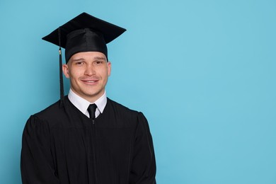Photo of Happy student after graduation on light blue background. Space for text