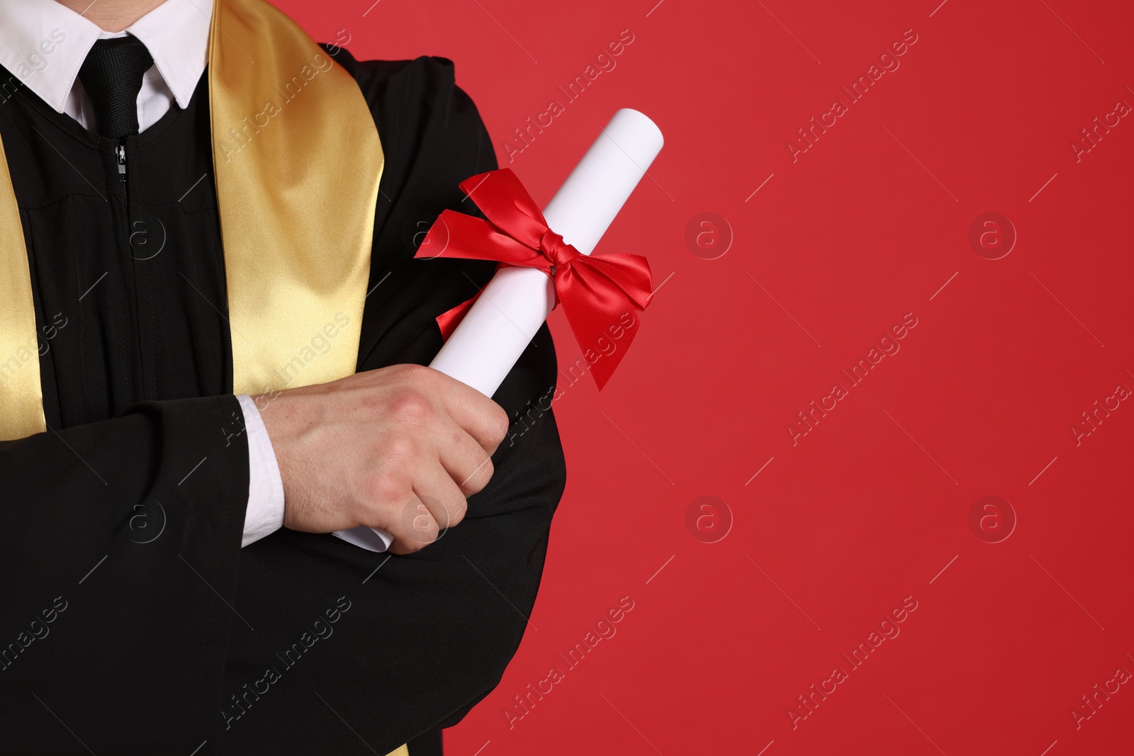 Student with diploma after graduation on red background, closeup. Space for text Photo of Student with diploma after graduation on red background, closeup. Space for text