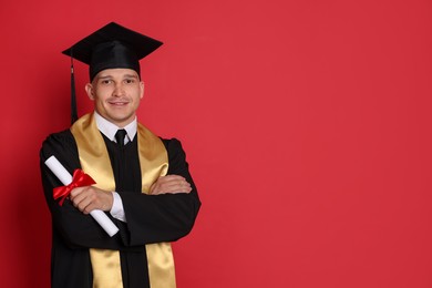 Photo of Happy student with diploma after graduation on red background. Space for text