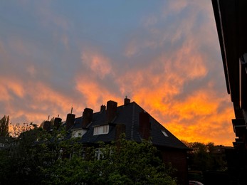 Photo of View of residential building against beautiful sky on sunset