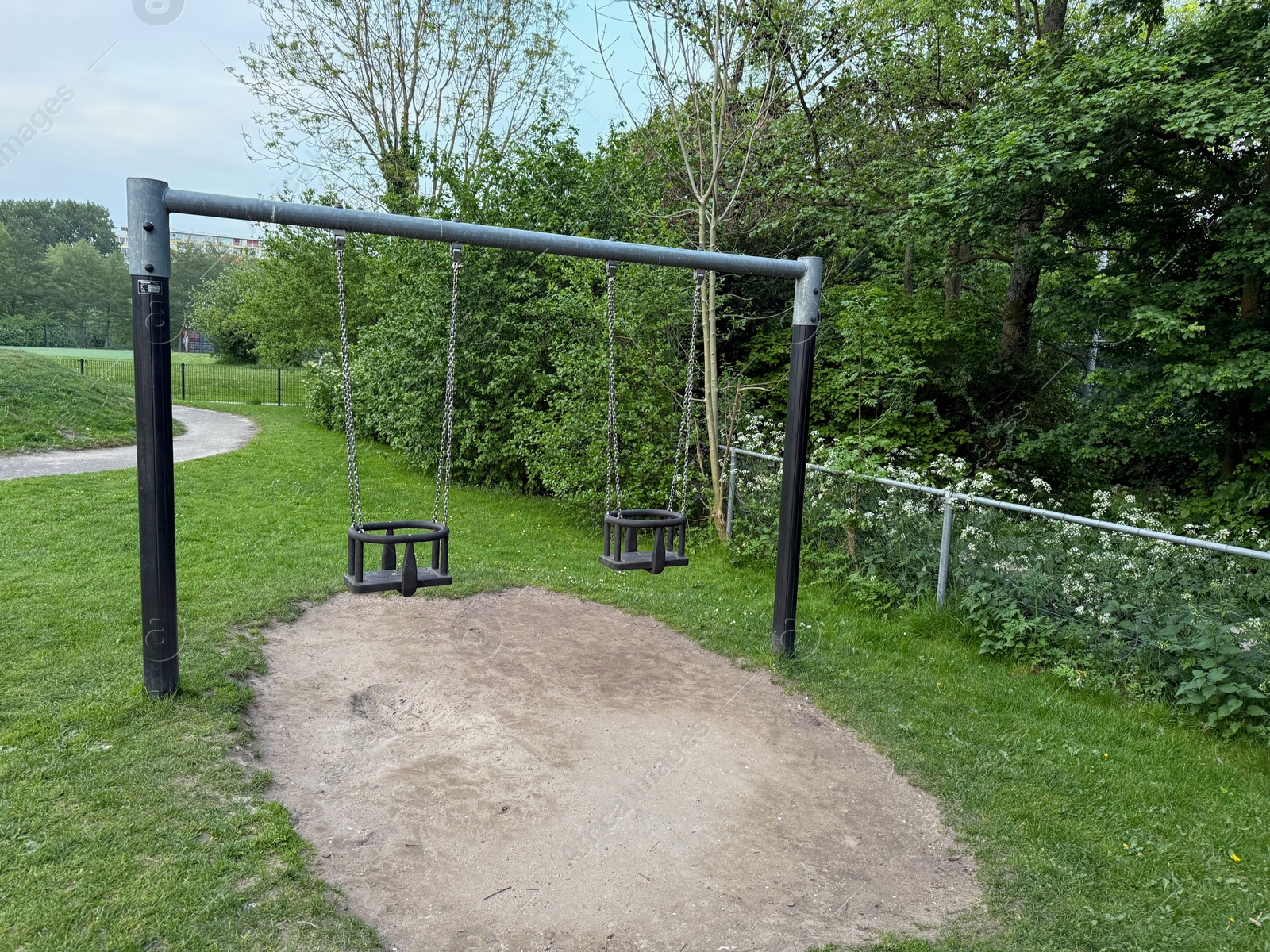 Empty swing set on playground in park Photo of Empty swing set on playground in park