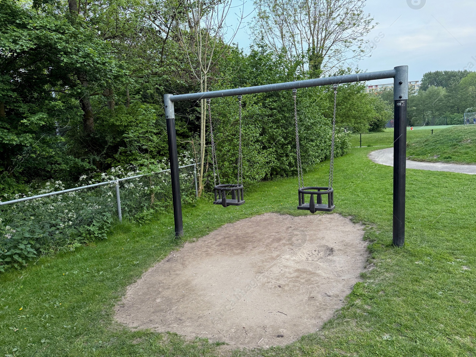 Empty swing set on playground in park Photo of Empty swing set on playground in park