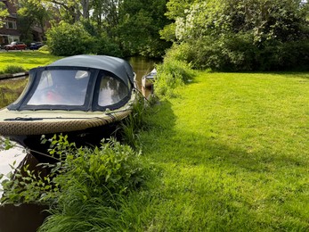 Photo of Beautiful canal with moored boat in park