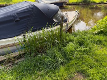 Photo of Beautiful canal with moored boat in park