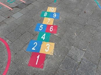 Photo of Hopscotch game drawn on asphalt outdoors, above view