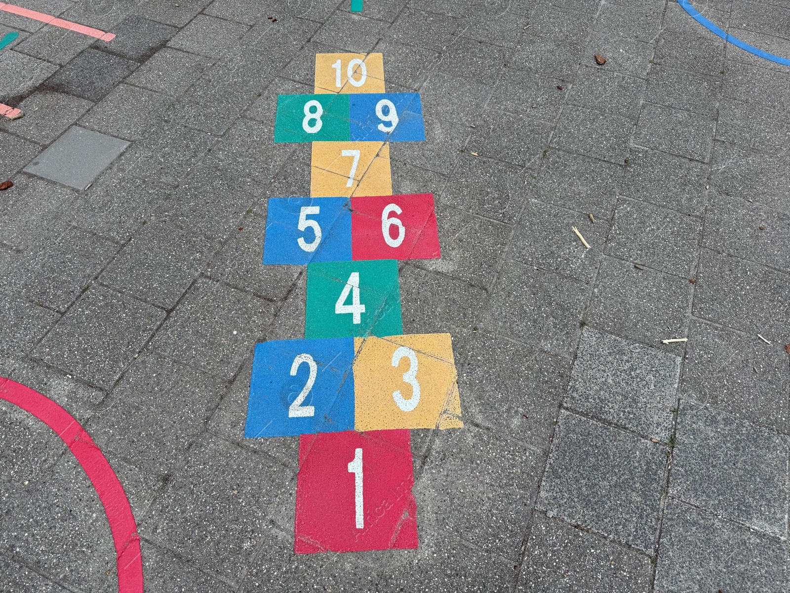 Hopscotch game drawn on asphalt outdoors, above view Photo of Hopscotch game drawn on asphalt outdoors, above view