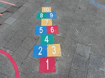 Photo of Hopscotch game drawn on asphalt outdoors, above view
