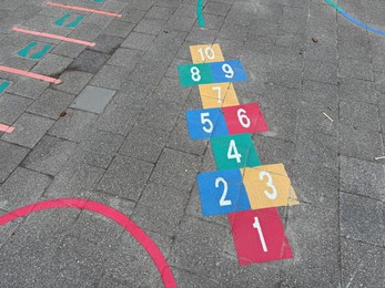 Photo of Hopscotch game drawn on asphalt outdoors, above view
