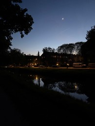 Photo of Picturesque view of canal and city street at night