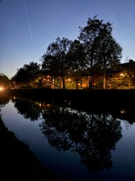 Photo of Picturesque view of canal and city street at night
