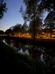 Photo of Picturesque view of canal and city street at night