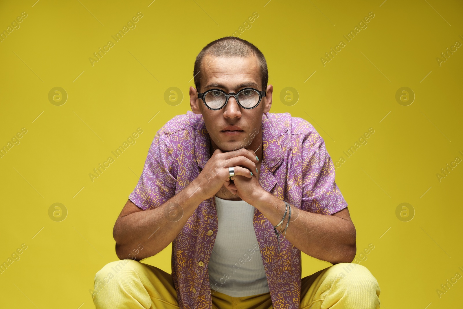 Fashionable portrait of handsome man in stylish outfit on color background Photo of Fashionable portrait of handsome man in stylish outfit on color background
