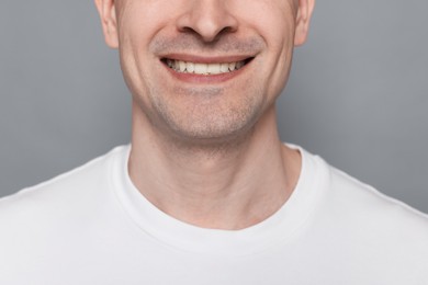 Photo of Smiling man after shaving on grey background, closeup