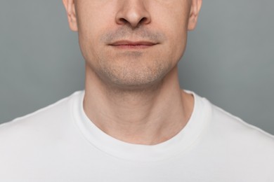 Photo of Man after shaving on grey background, closeup