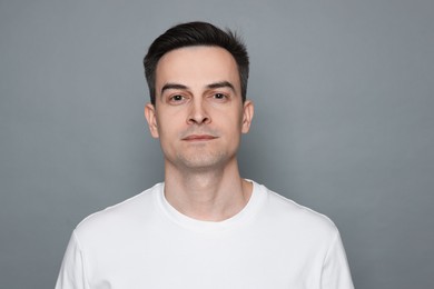 Photo of Portrait of man after shaving on grey background