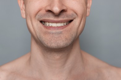 Photo of Smiling man after shaving on grey background, closeup