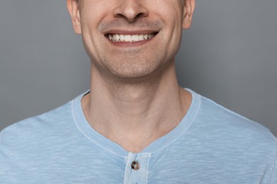 Photo of Smiling man after shaving on grey background, closeup