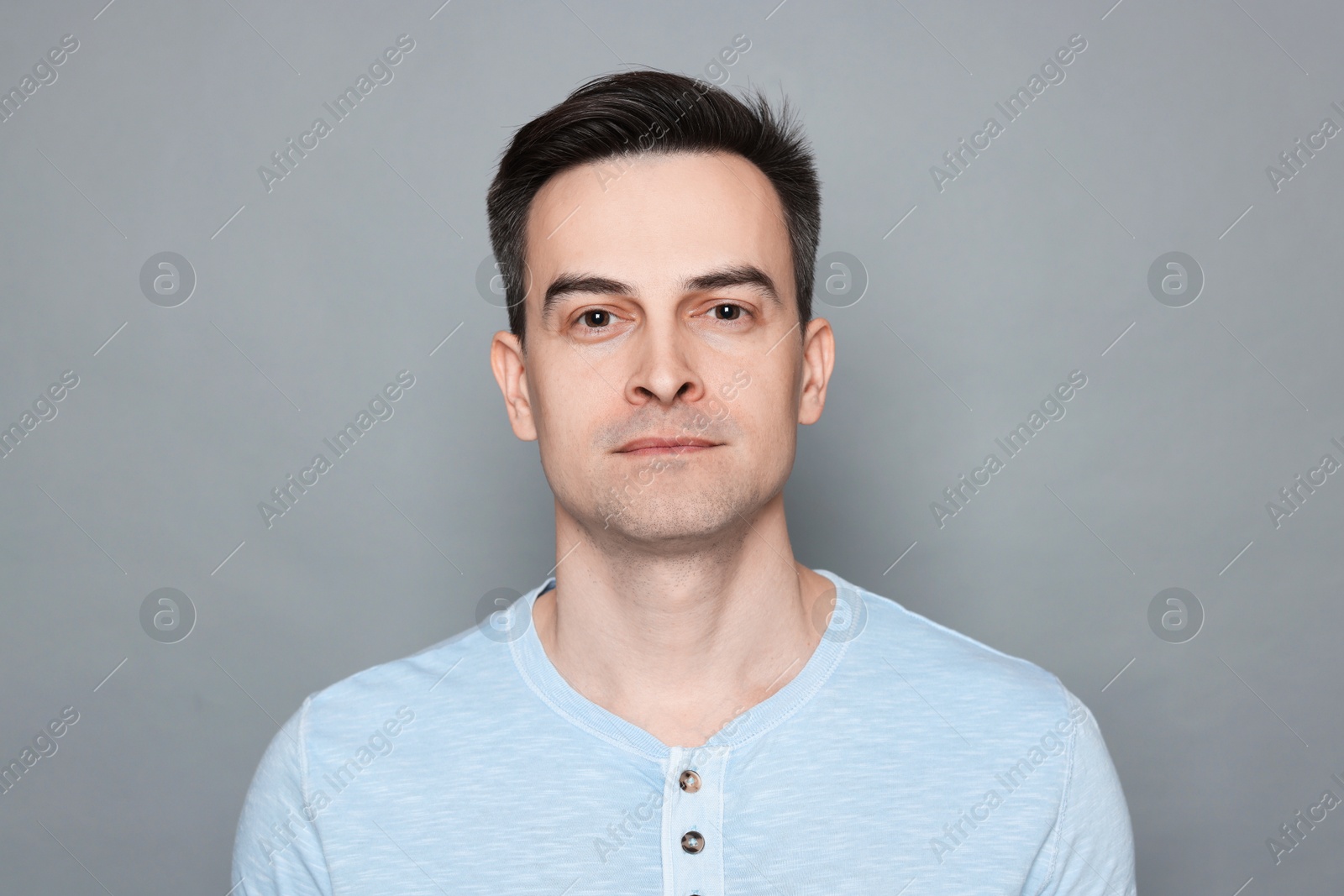 Portrait of man after shaving on grey background Photo of Portrait of man after shaving on grey background