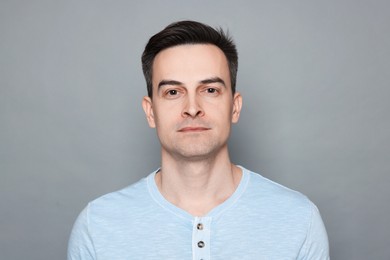 Photo of Portrait of man after shaving on grey background
