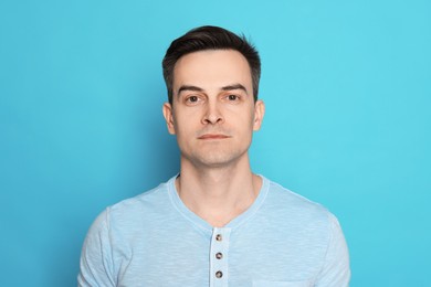 Photo of Handsome man after shaving on light blue background
