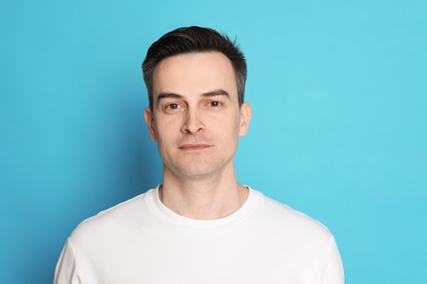 Photo of Handsome man after shaving on light blue background