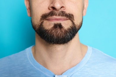 Photo of Man before shaving on light blue background, closeup