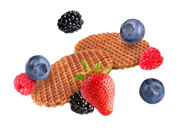 Image of Tasty Dutch waffles and fresh berries flying on white background
