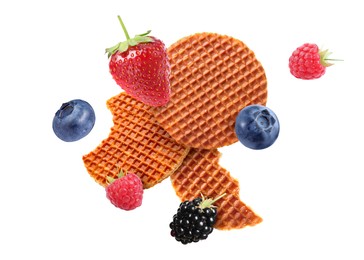 Image of Tasty Dutch waffles and fresh berries flying on white background
