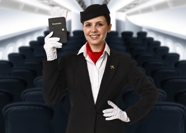 Image of Smiling stewardess holding passport with flight tickets in airplane cabin