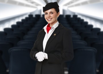 Image of Smiling stewardess in airplane cabin with comfortable seats