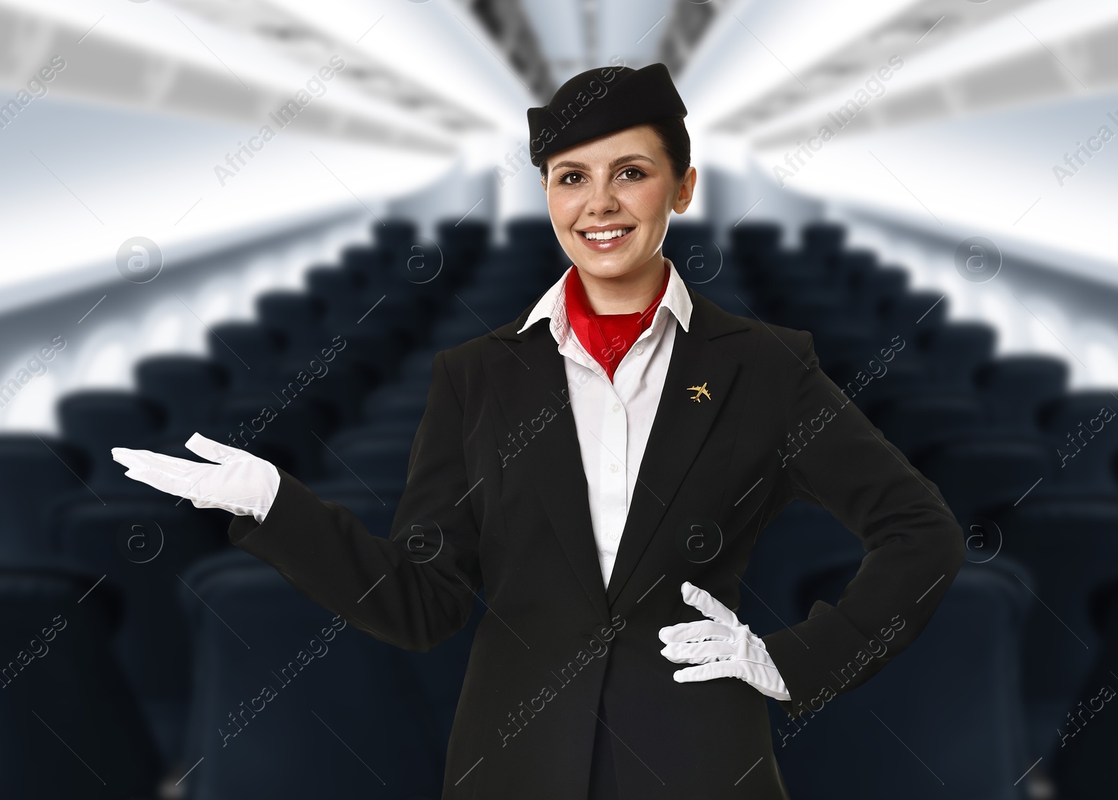Smiling stewardess welcoming passengers in airplane cabin Image of Smiling stewardess welcoming passengers in airplane cabin