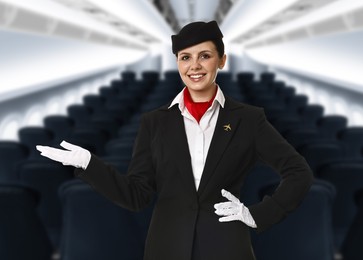 Image of Smiling stewardess welcoming passengers in airplane cabin