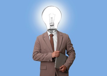 Image of Man with glowing lightbulb instead of head and laptop on light blue background