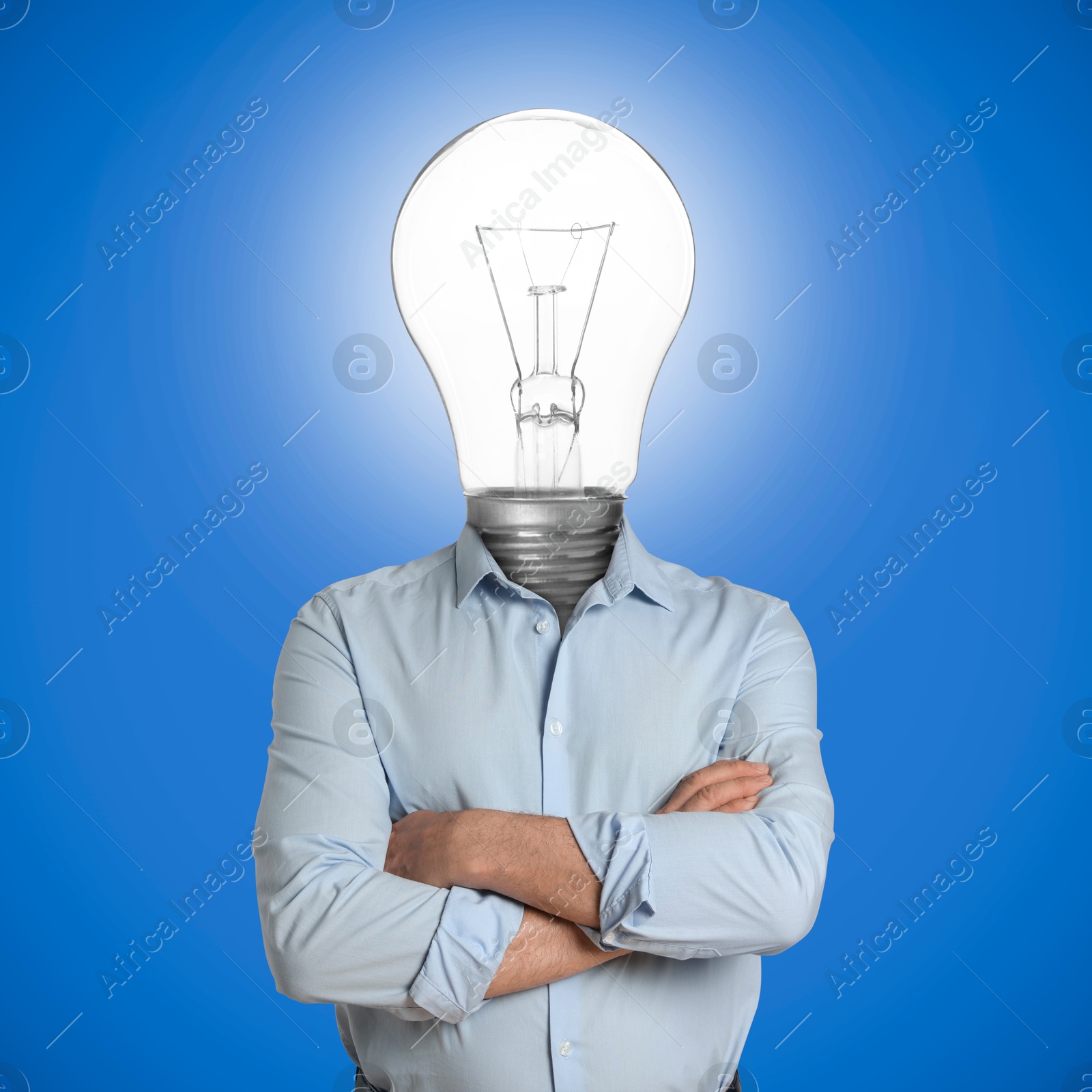 Man with glowing lightbulb instead of head on light blue background Image of Man with glowing lightbulb instead of head on light blue background