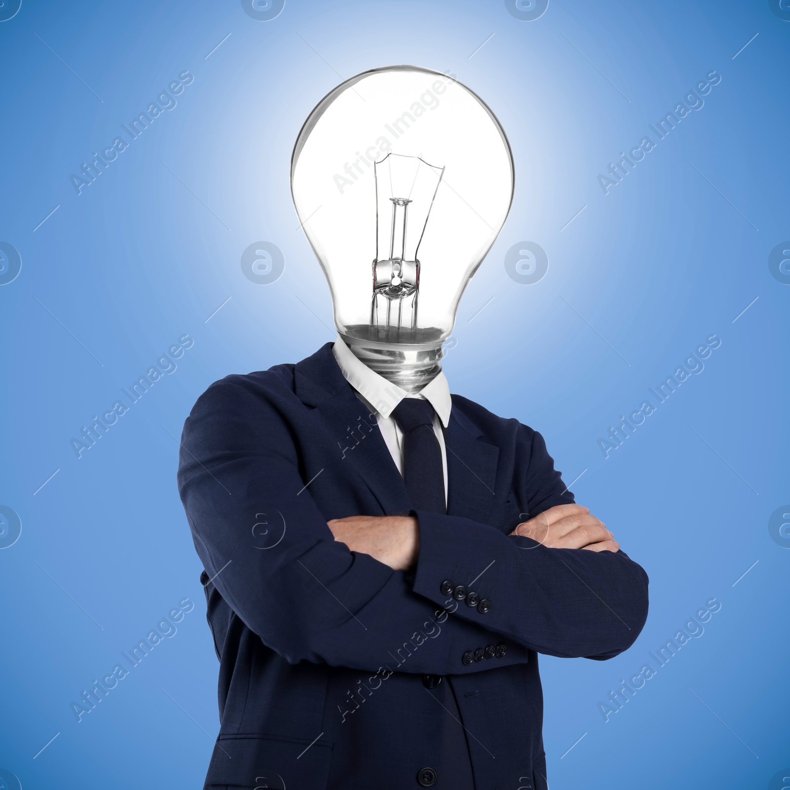 Man with glowing lightbulb instead of head on light blue background Image of Man with glowing lightbulb instead of head on light blue background