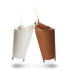 Image of Chocolate drink and milk splashing out of glasses on white background