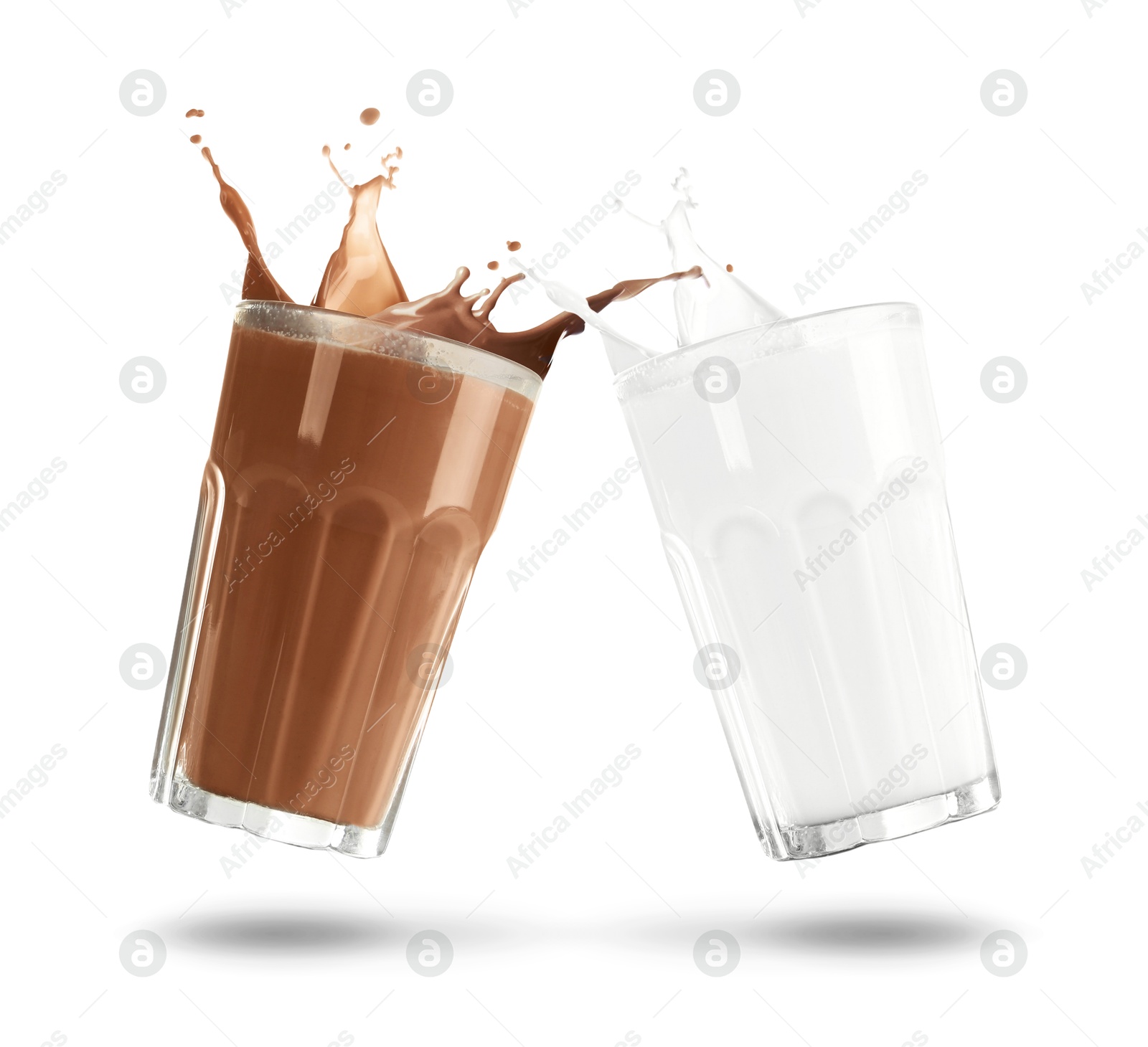Chocolate drink and milk splashing out of glasses on white background Image of Chocolate drink and milk splashing out of glasses on white background