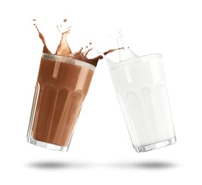 Image of Chocolate drink and milk splashing out of glasses on white background