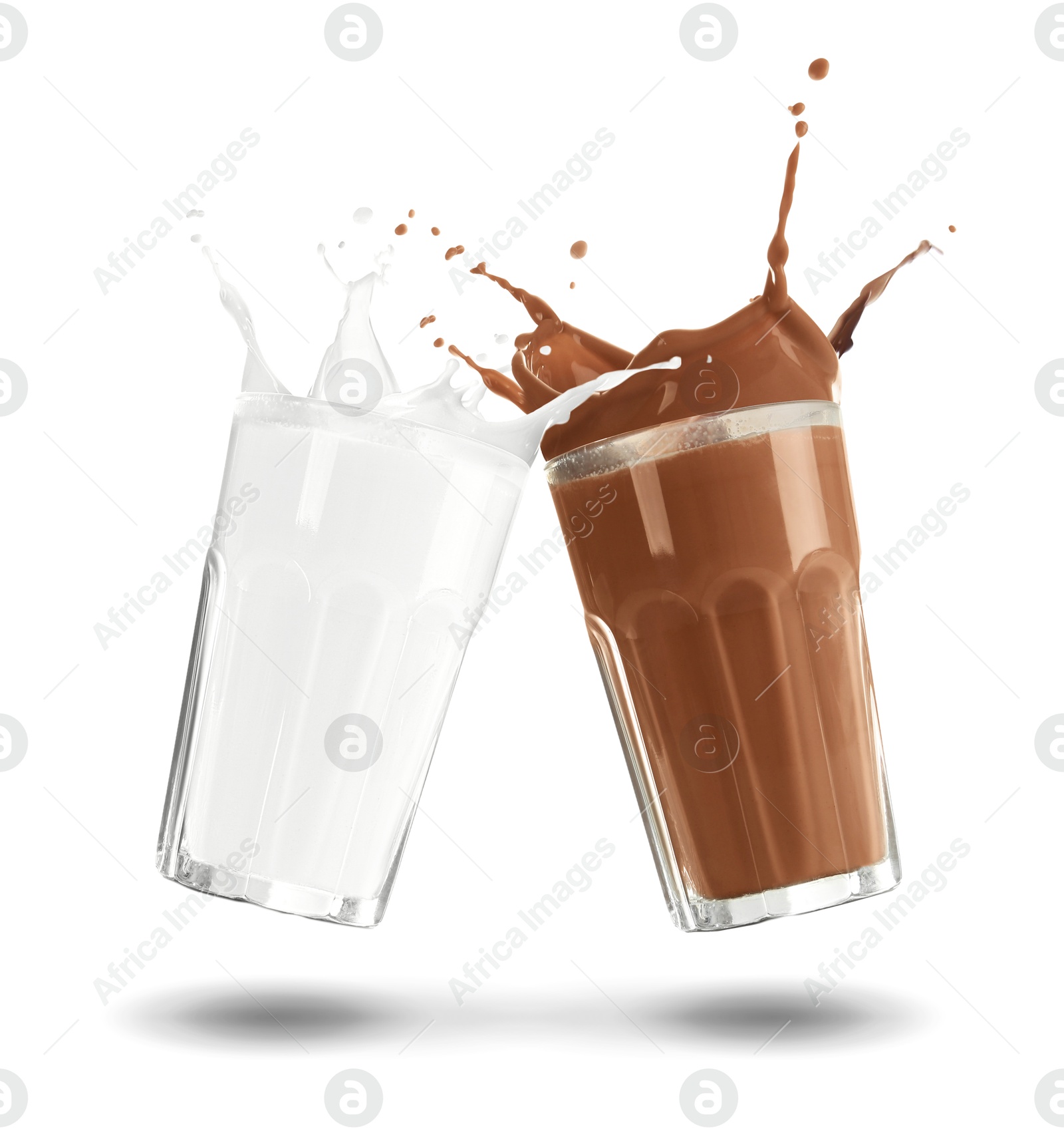 Chocolate drink and milk splashing out of glasses on white background Image of Chocolate drink and milk splashing out of glasses on white background