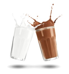 Image of Chocolate drink and milk splashing out of glasses on white background