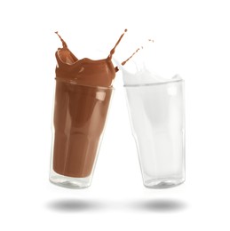 Image of Chocolate drink and milk splashing out of glasses on white background