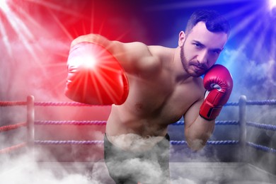 Image of Boxer surrounded by smoke fighting in ring. Sporting event