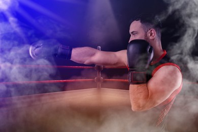 Image of Boxer surrounded by smoke fighting in ring. Sporting event